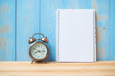 Close-up of clock on open book