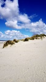 Scenic view of beach against blue sky