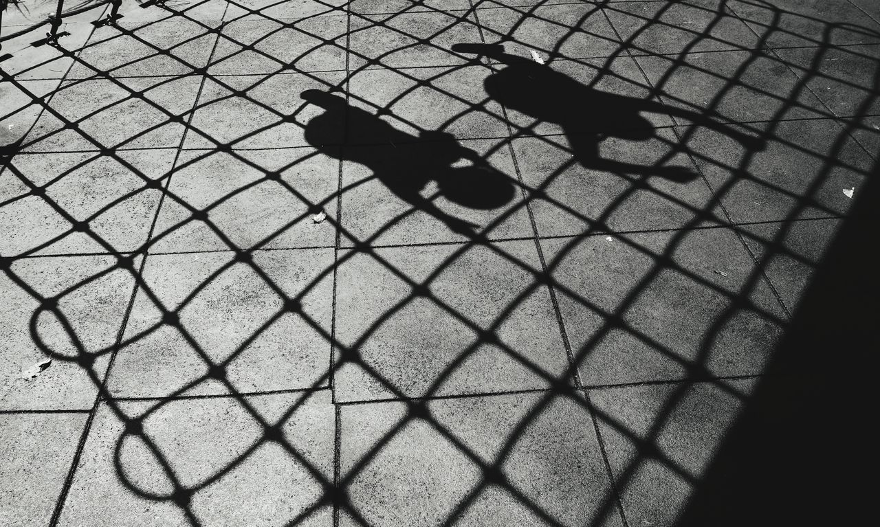 black, shadow, high angle view, sunlight, line, black and white, monochrome, day, pattern, nature, monochrome photography, no people, outdoors, circle, footpath, street, white, metal, city, flooring, fence, security