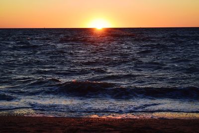Scenic view of sea against clear sky during sunset