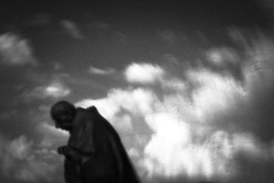 Low angle view of silhouette statue against sky