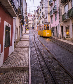 Railroad tracks amidst buildings in city