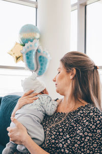 Woman holding umbrella at home