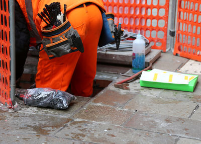 Orange working on footpath