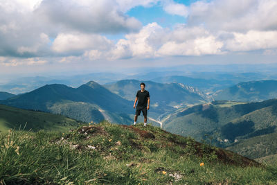 Athlete in a black t-shirt poses on top of the mala fatra mountain. climbing mount hromova. a hiker 