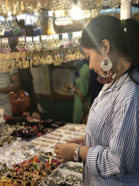 Woman buying jewelry at shop