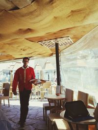 Portrait of man standing in restaurant