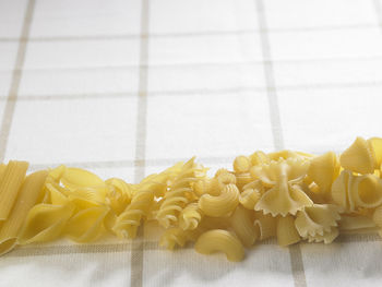 High angle view of various pastas on fabric