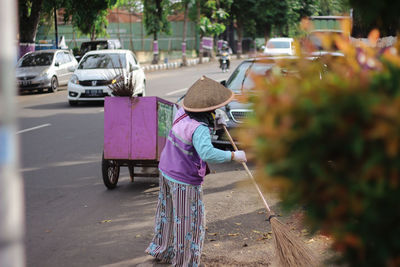 Rear view of women with umbrella on street