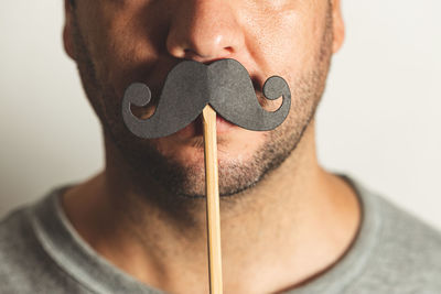 Close-up portrait of man against white background