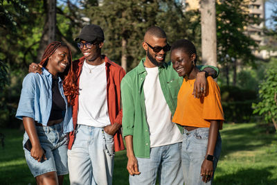 Pleasant double date between two happy african american romantic couples in love outside outdoors
