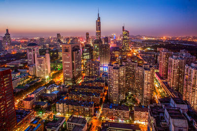 Aerial view of city lit up at night