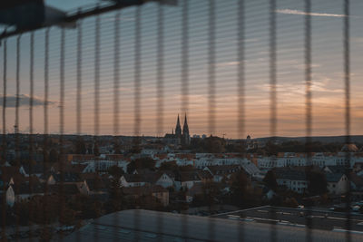 Buildings in city against sky during sunset