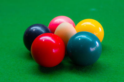 Close-up of colorful balls with egg arranged on table