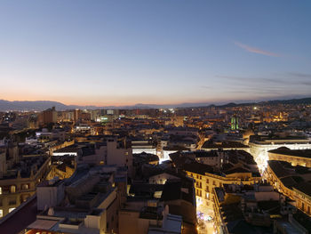 High angle view of illuminated buildings in city against sky