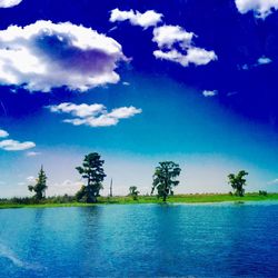 Scenic view of lake against cloudy sky