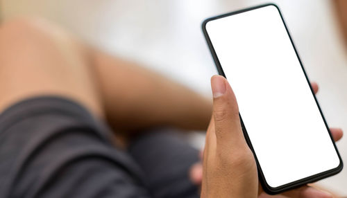 Close-up of hand holding mobile phone