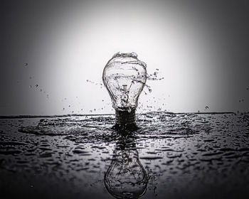 Close-up of water splashing in sea against sky