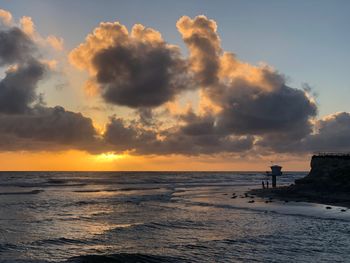 Sunset at cardiff state beach with lifeguard tower in san diego, california