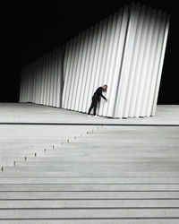 Side view of man walking on staircase
