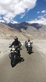 People riding motorcycles on road