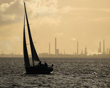 Ship sailing in sea against sky