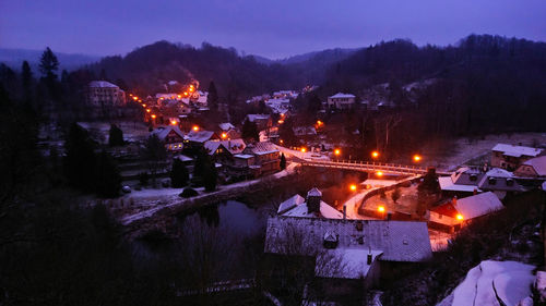 High angle view of illuminated buildings in city at night