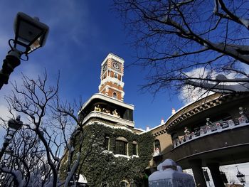 Low angle view of building and trees against sky
