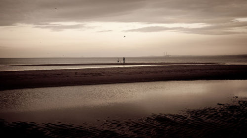 Scenic view of sea against sky at sunset