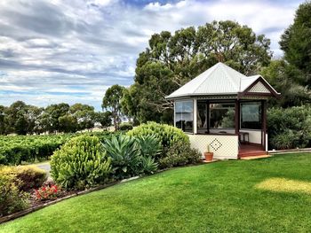Built structure by trees against sky