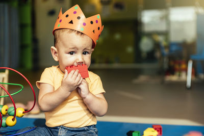 Portrait of cute boy holding toy