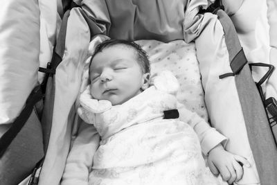 High angle view of baby relaxing on bed