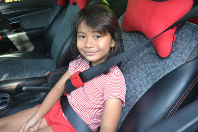 Portrait of cute girl sitting in car