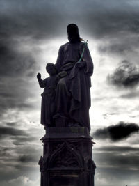 Low angle view of statue against cloudy sky
