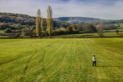 High angle view of boy standing on grassy field