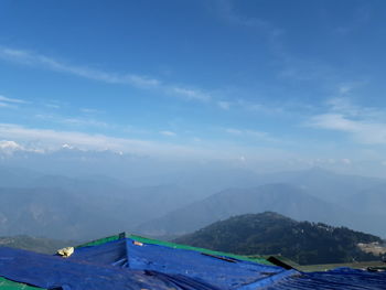 Scenic view of mountains against blue sky