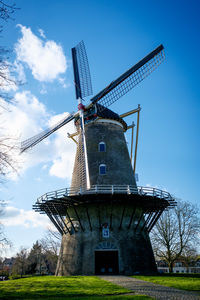 Low angle view of crane against sky