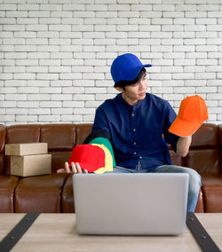 Man using mobile phone while sitting on sofa