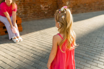 Rear view of woman walking on street