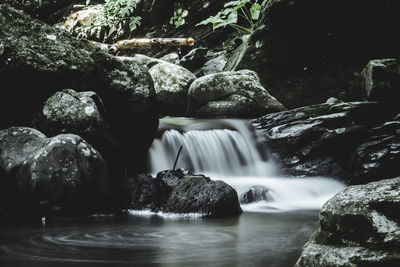 Stream flowing through rocks in forest