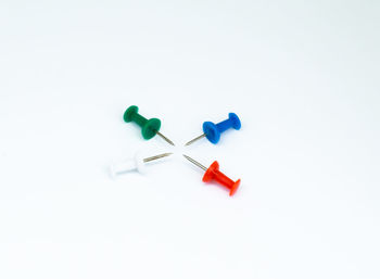 High angle view of colored pencils over white background