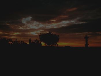 Silhouette trees on landscape against sunset sky