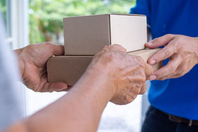 Midsection of man holding hands in box