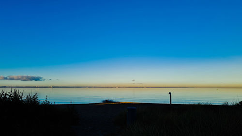 Scenic view of sea against blue sky