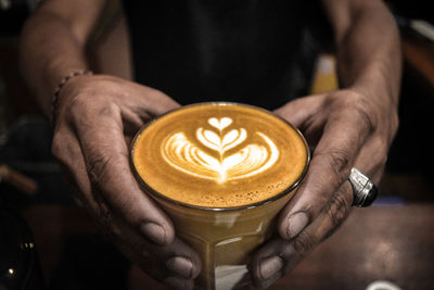 Close-up of hand holding coffee cup