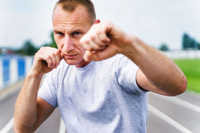 Portrait of man with arms raised