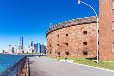 View of buildings against clear blue sky