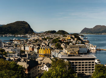 High angle view of townscape by sea against sky