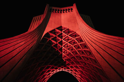 Low angle view of illuminated building against sky at night