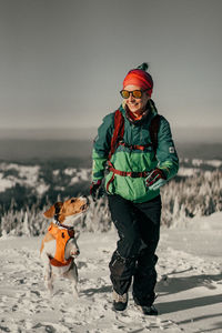 Full length of man standing on snow covered landscape